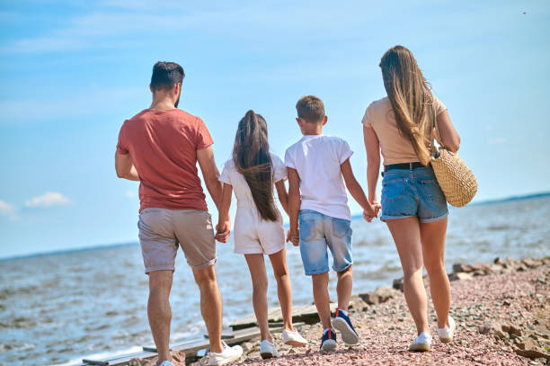 istock A family walking on a shore holding hands 1341063670