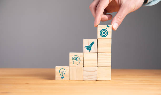 istock man holding target or goal on the cubes 1341064550