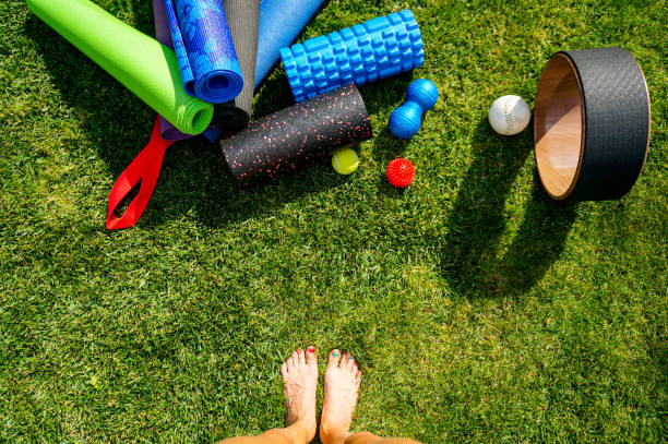 istock Yoga class outdoors. Woman barefoot is going to practice yoga 1341065270