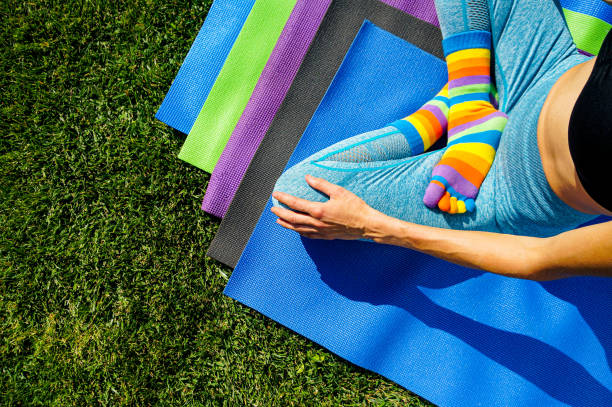 Woman practicing yoga in park green grass
