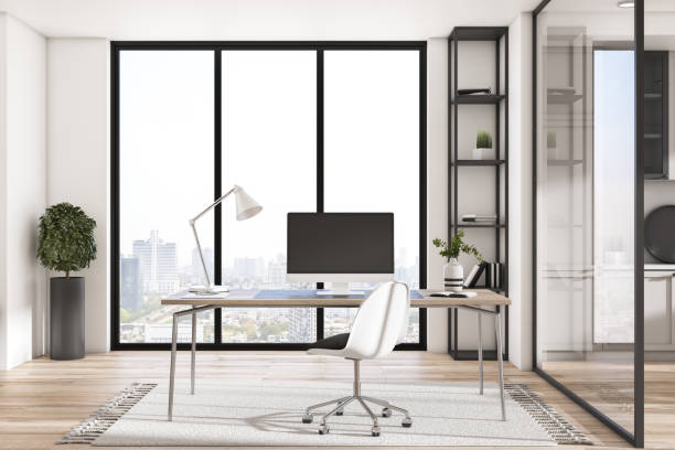 istock Empty computer monitor in creative contemporary daylight office studio interior with glass partition and window with city view, wooden flooring. Workplace and architecture concept. Mock up, 3D Rendering. 1341068920