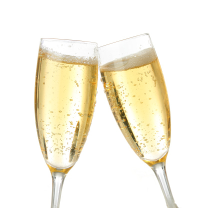 Pair of champagne flutes making a toast.