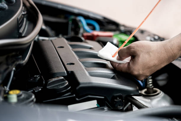 istock Home service car concept : A man check level of engine oil and see the stains from use basic maintenance of car 1341071506