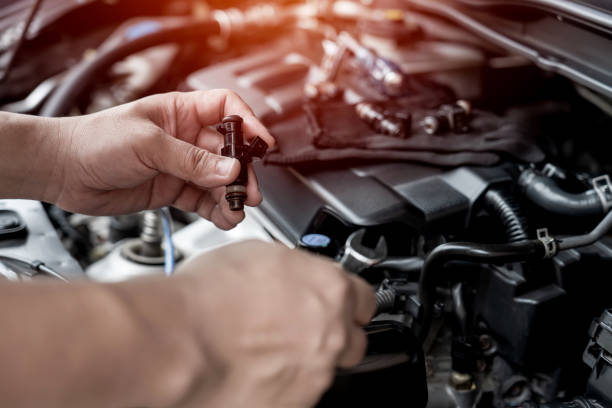 il tecnico usa la chiave inglese rimuovendo la parte dell'iniettore di benzina sul controllo e l'assistenza del concetto di manutenzione del motore - power car foto e immagini stock