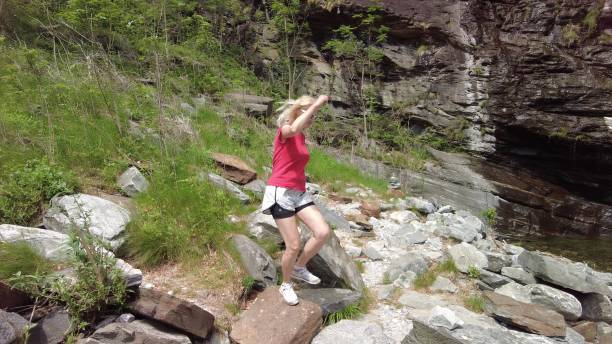 istock woman in great waterfall of Bignasco 1341072416