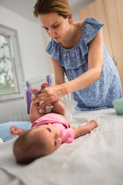 istock Mother changing the baby's diaper 1341072483