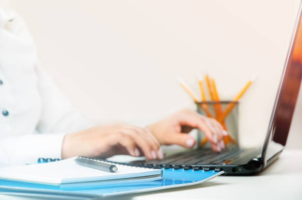 istock Documents, laptop and woman hands on keyboard 1341074799