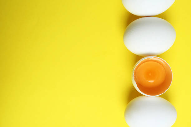 istock Fresh raw chicken eggs on yellow background, flat lay. Space for text 1341079772