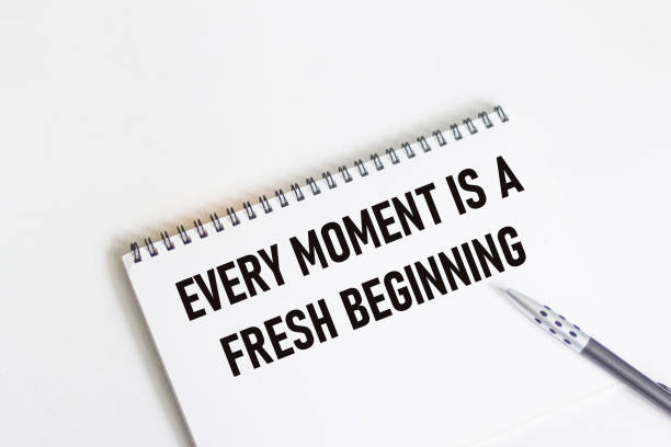 istock Every moment is a new beginning. Inspirational quote on notepad with pen. 1341079806