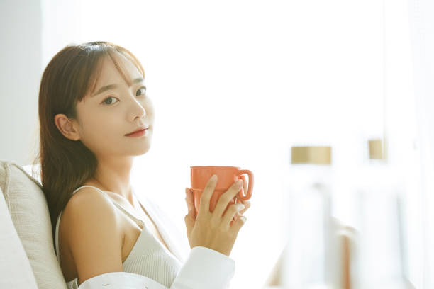 istock A young Asian woman relaxing on the sofa 1341079994