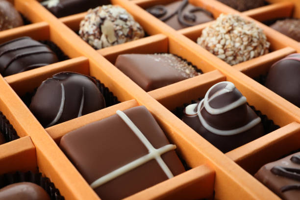 istock Box with different chocolate candies as background, closeup 1341080124