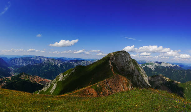 istock steep mountain with a summit cross and amazing mountain landscape panorama 1341083131