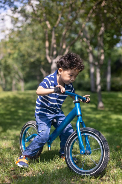 istock A boy riding a bike on the lawn 1341084134