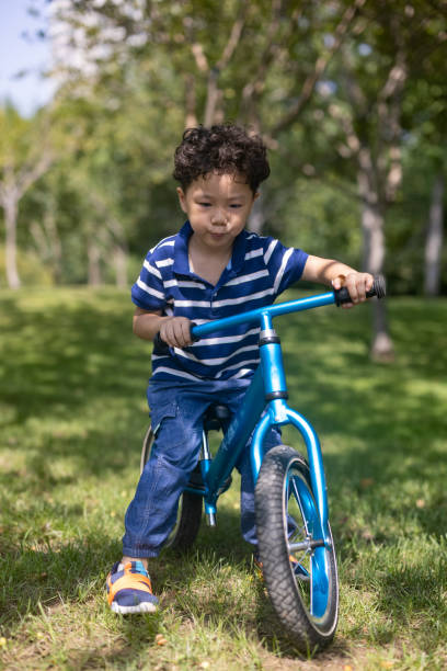 istock A boy riding a bike on the lawn 1341084135