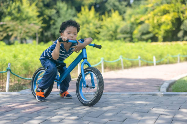 istock A little boy learning to ride a bike 1341084180