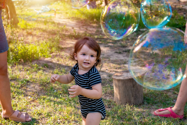 istock Happy carefree toddler boy blowing soap bubbles 1341084555