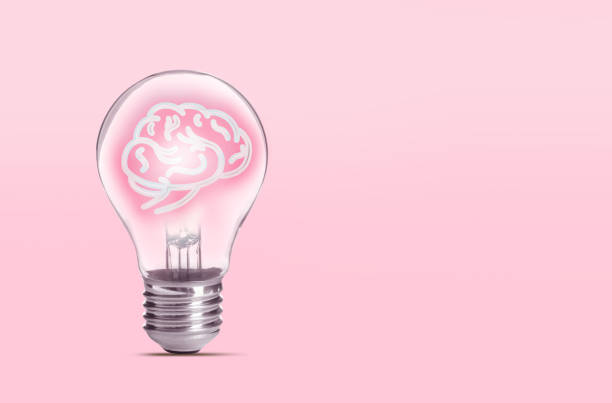 istock Lamp bulb with human brain inside on pink background, space for text. Idea generation 1341085604