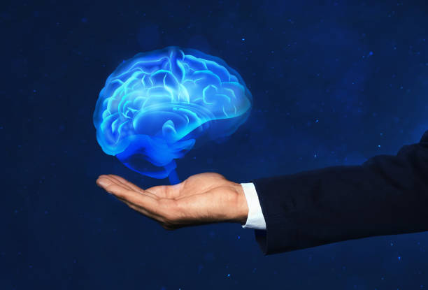 istock Young man holding digital image of brain on blue background, closeup 1341085646