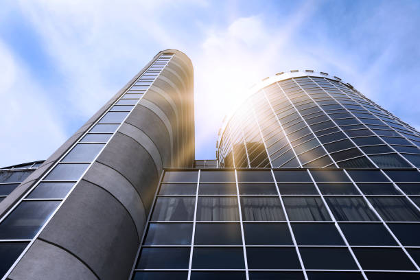 istock Modern skyscraper with tinted windows against blue sky, low angle view. Building corporation 1341085794