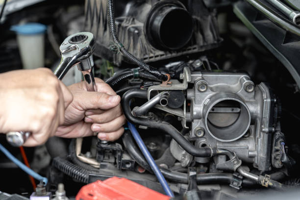istock Close up wrench in hand a man  remove bolt of engine in car service engine throttle valve cleaning and maintenance : car service concept photo 1341086528