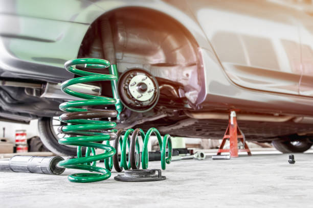 Coil spring and shock absorber on the service shop change and remove old part car maintenance concept