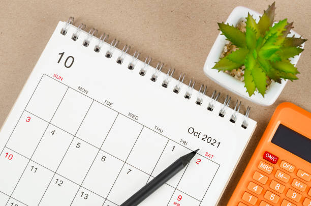 istock October 2021 desk calendar with calculator 1341087956