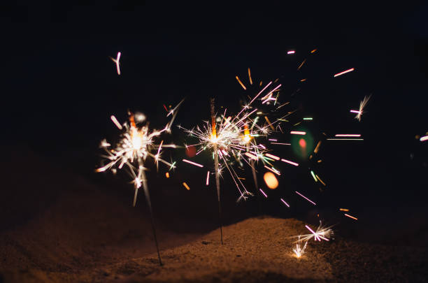 istock Romantic nighttime background with sparks. Beach sand at night w 1341088781