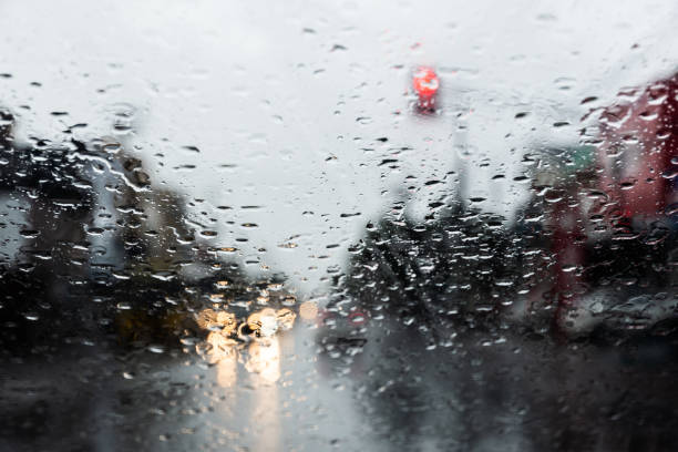 istock Blurred colored lights through the car window with raindrops. 1341089070