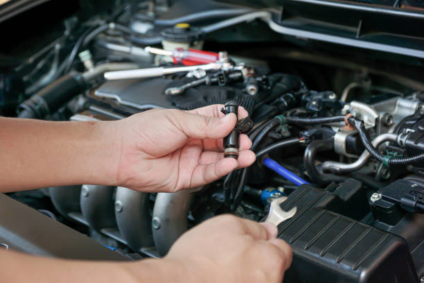 istock Technician Removing the petrol engine injector in engine room maintenance concept 1341090340