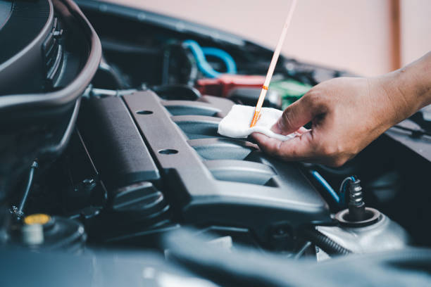 istock Home service car concept : A man check level of engine oil and see the stains from use basic maintenance of car 1341090376