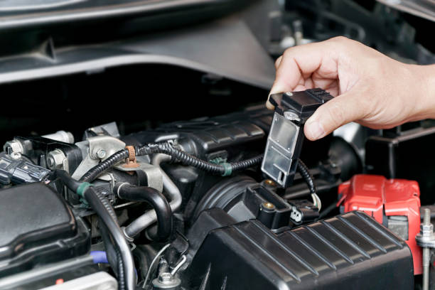 istock Close up hand a Technician remove airflow sensor in the engine room car for check and cleaning in service concept 1341090399