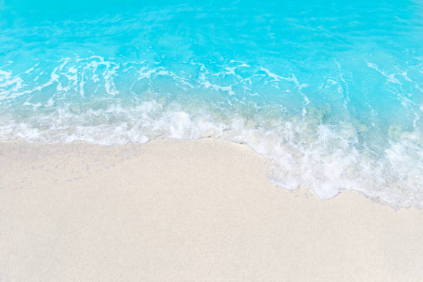 istock Sea wave and bubble on a sandy white beach blue sea background texture and copy space holiday concept 1341090558