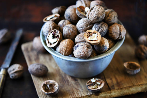 istock Walnuts in a bowl on a dark background. 1341091645