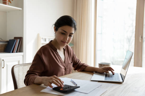 istock Focused young indian female calculate utilities before make online payment 1341094130