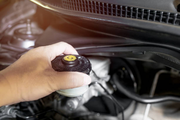 istock Close up hand a man checking brake fluid maintenance and basic service concept in the car and brake system 1341094445