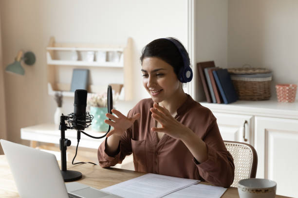 indian woman in headphones speak using professional microphone by laptop - indian ethnicity audio imagens e fotografias de stock