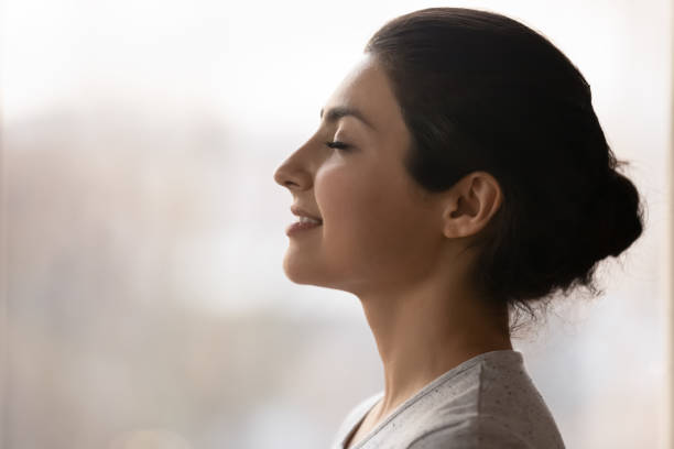 Calm millennial indian lady breath deep meditate with closed eyes Meditation. Side profile shot of happy serene young indian female face. Calm millennial ethnic lady breath deep with closed eyes meditate feel zen good harmony peace of mind practice yoga meet new day side eye expression stock pictures, royalty-free photos & images