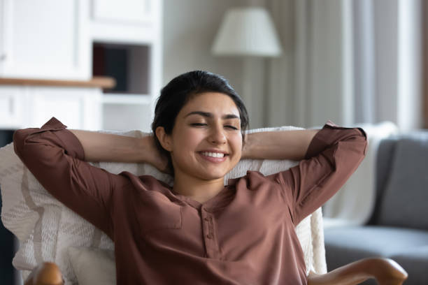 istock Tranquil young indian female sit on comfy chair enjoy rest 1341094536