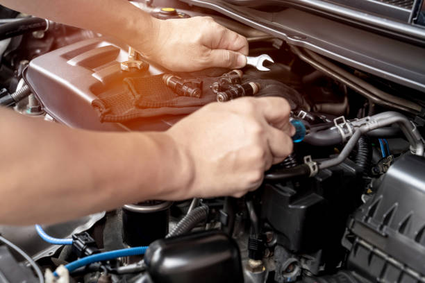 istock Technician use wrench and screwdriver removing the gasoline injector part on engine  maintenance concept check and service 1341095412