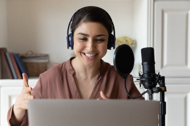 istock Indian female reader in headset record audiobook using special equipment 1341095613