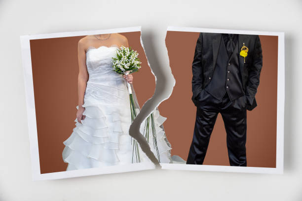 torn photo of a marriage Divorce concept. Torn photograph of a couple at their wedding with red background wedding dress photos stock pictures, royalty-free photos & images