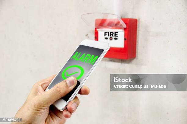Connecting The Smoke Detector With A Smart Phone Stock Photo - Download Image Now - Mobile App, Telephone, Crash
