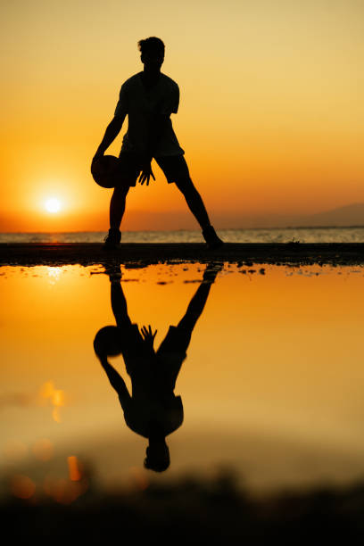 istock Young man practices basketball at sunset 1341096408