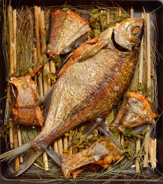 istock Long-cooked fish. Baked in a Russian stove on straw 1341096745