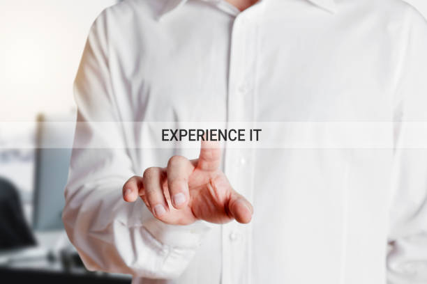 istock Businessman presses on virtual touch screen with the words experience it. Business training and skill development. 1341096979