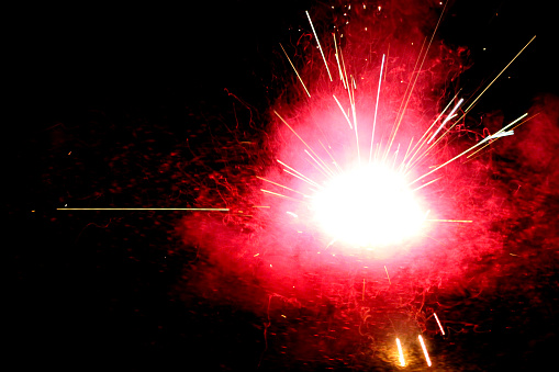 Ground Spinner Firework with lots of sparks and smoke in the street
