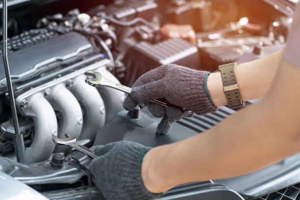 istock Technician is using a wrench working in auto service. Car repair and maintenance. 1341101616