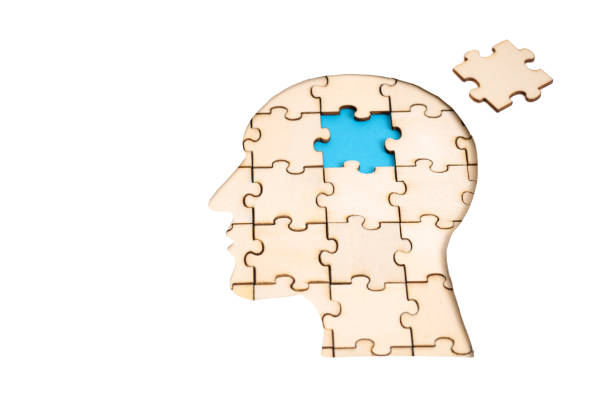 istock Man's head shaped jigsaw puzzle with the final piece isolated on white 1341102528