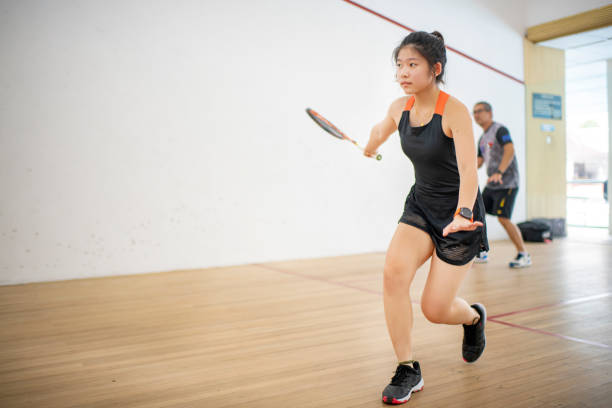 istock Asian squash coach father guiding teaching his daughter squash sport practicing together in squash court 1341102557
