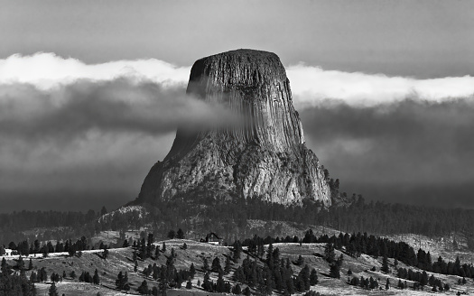 devil's tower on a foggy morning in black and white
